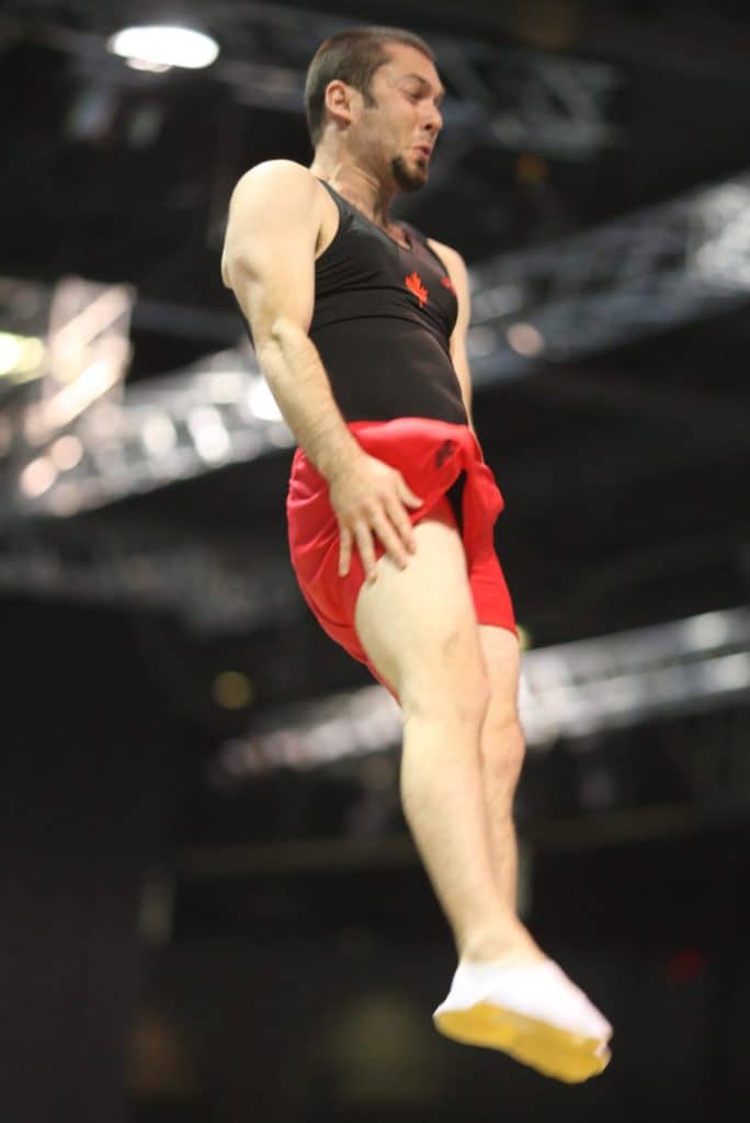 male trampoline athlete twisting in the air